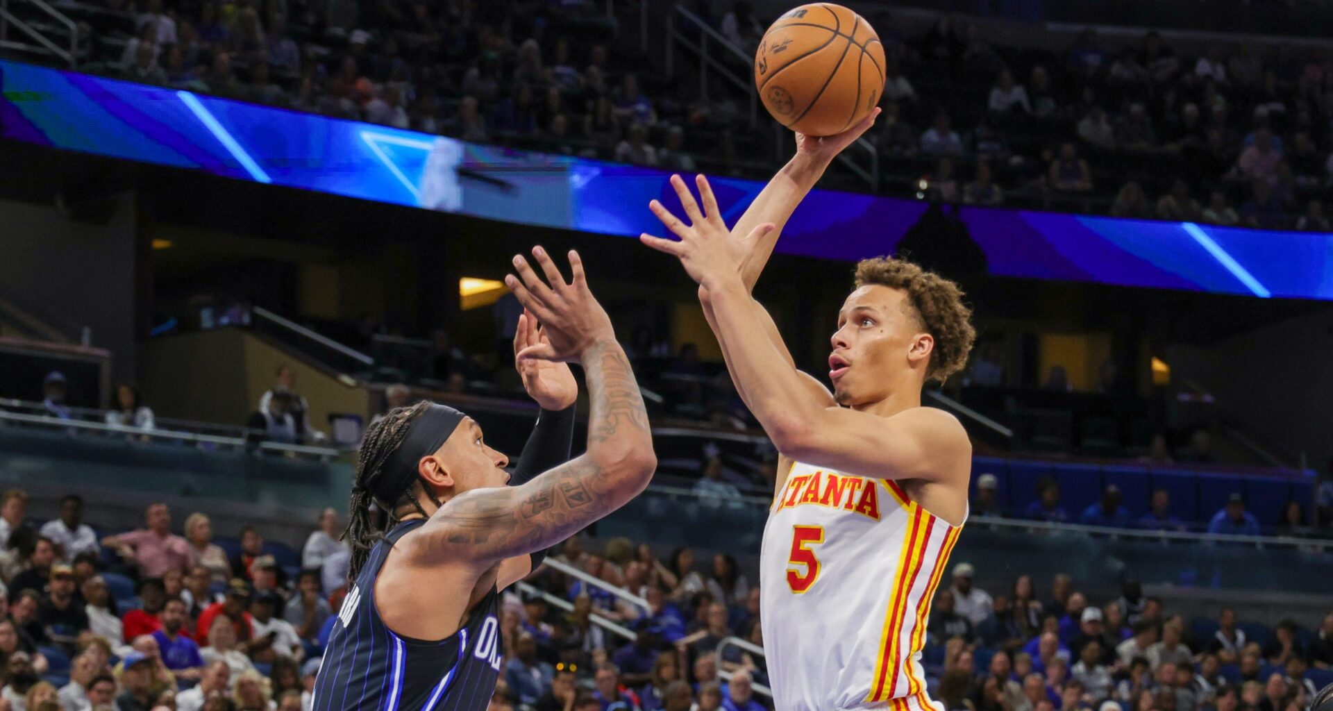 Apr 8, 2025; Orlando, Florida, USA; Atlanta Hawks guard Dyson Daniels (5) shoots the ball over Orlando Magic forward Paolo Banchero (5) during the second quarter at Kia Center. Mandatory Credit: Mike Watters-Imagn Images