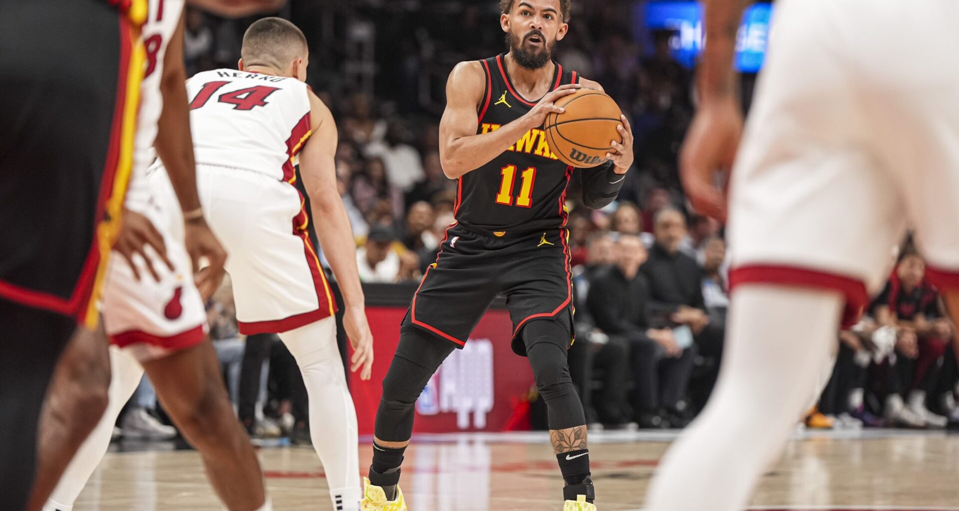 Atlanta Hawks guard Trae Young (11) controls the ball against Miami Heat guard Tyler Herro (14) during the first half at State Farm Arena.
