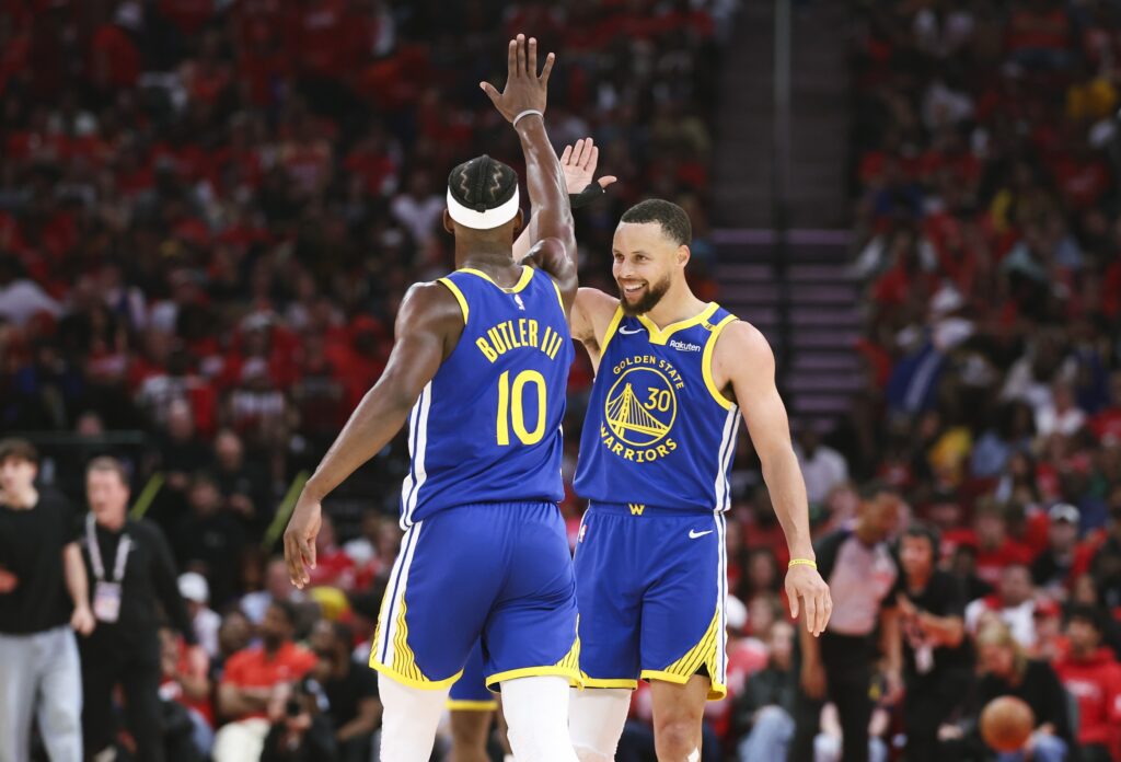 Apr 20, 2025; Houston, Texas, USA; Golden State Warriors guard Stephen Curry (30) celebrates with forward Jimmy Butler III (10) after a play during the third quarter against the Houston Rockets at Toyota Center. Mandatory Credit: Troy Taormina-Imagn Images
