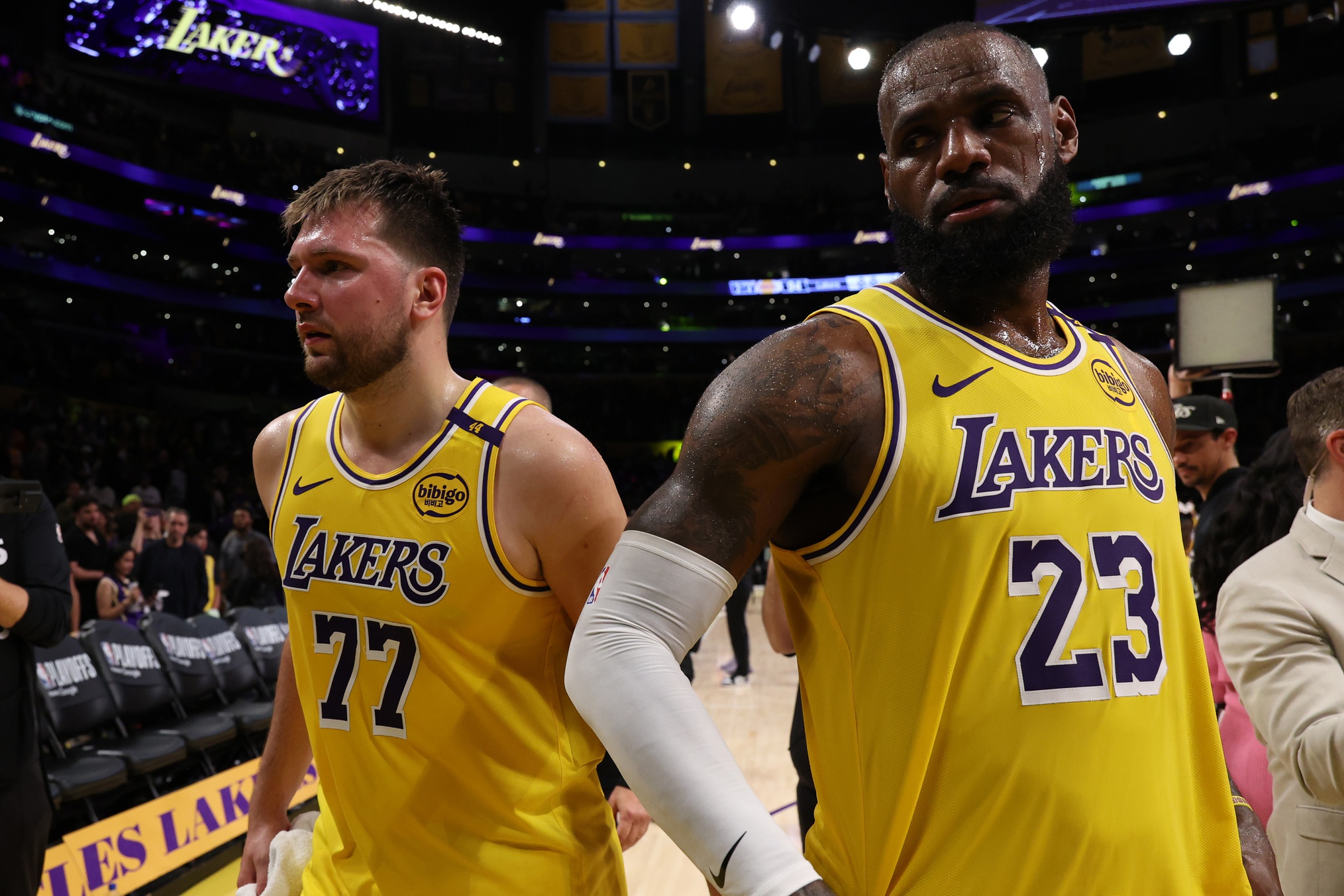 Apr 22, 2025; Los Angeles, California, USA; Los Angeles Lakers guard Luka Doncic (77) and Los Angeles Lakers forward LeBron James (23) leave a court after defeating the Minnesota Timberwolves 94-85 in game two of first round for the 2024 NBA Playoffs at Crypto.com Arena.