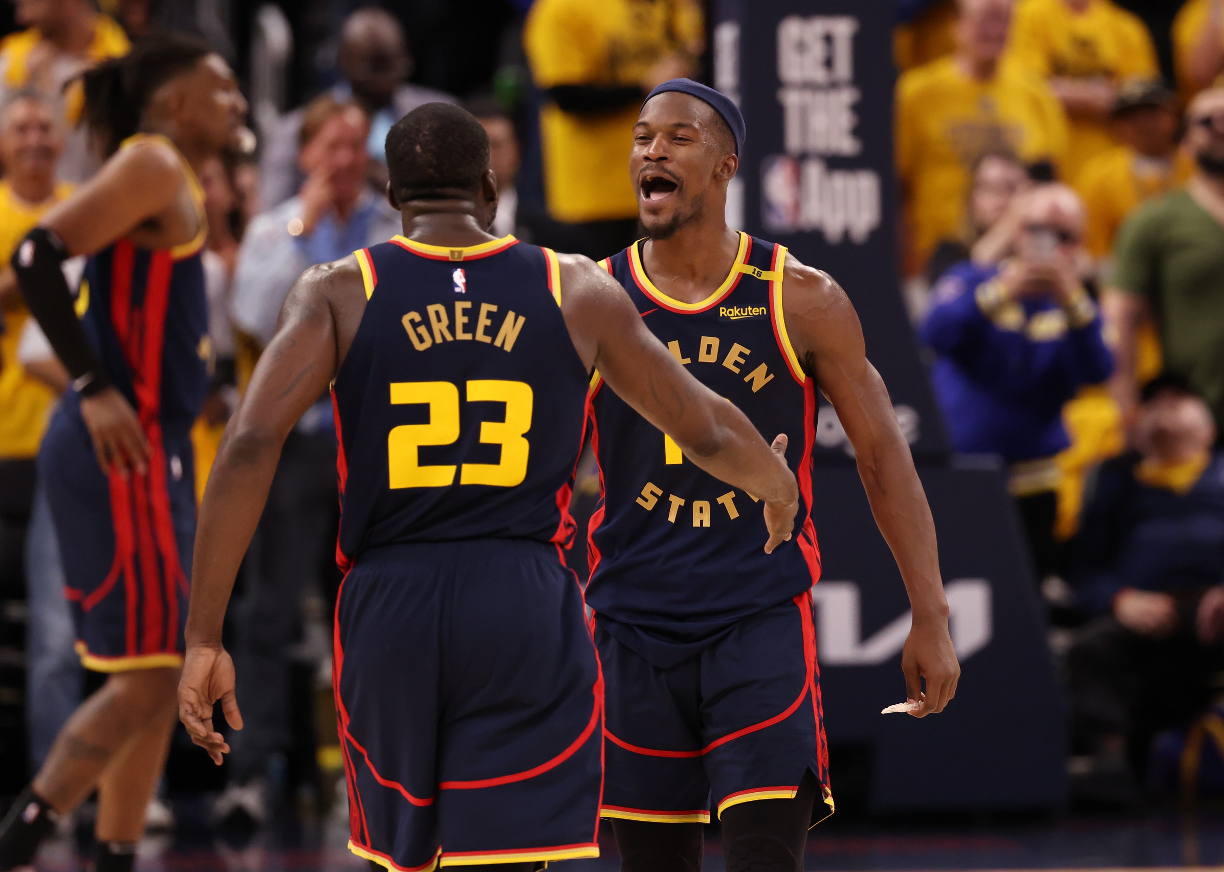 Golden State Warriors forward Draymond Green (23) celebrates with forward Jimmy Butler III (10) 