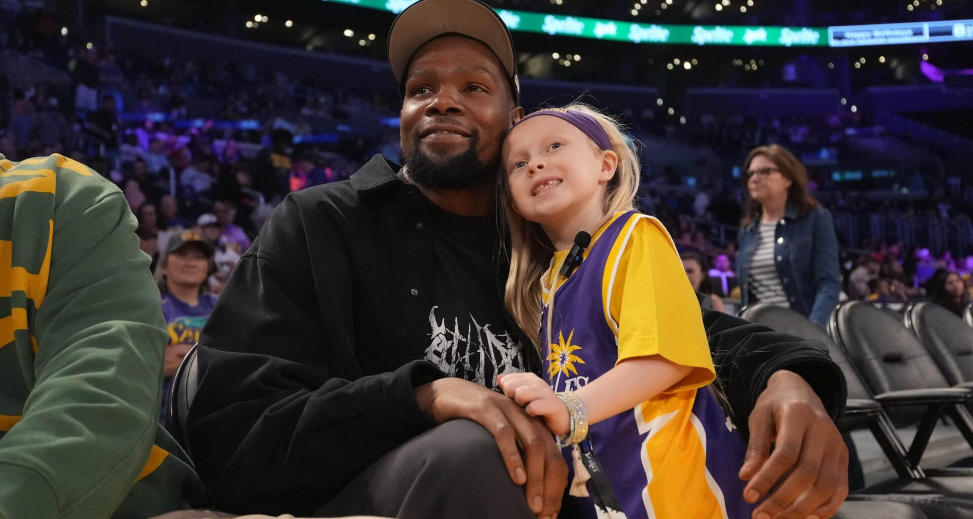 May 23, 2025; Los Angeles, California, USA; Kevin Durant poses with 8-year-old LA Sparks fan Vivian Havens during the game against the Golden State Valkyries at Crypto.com Arena.