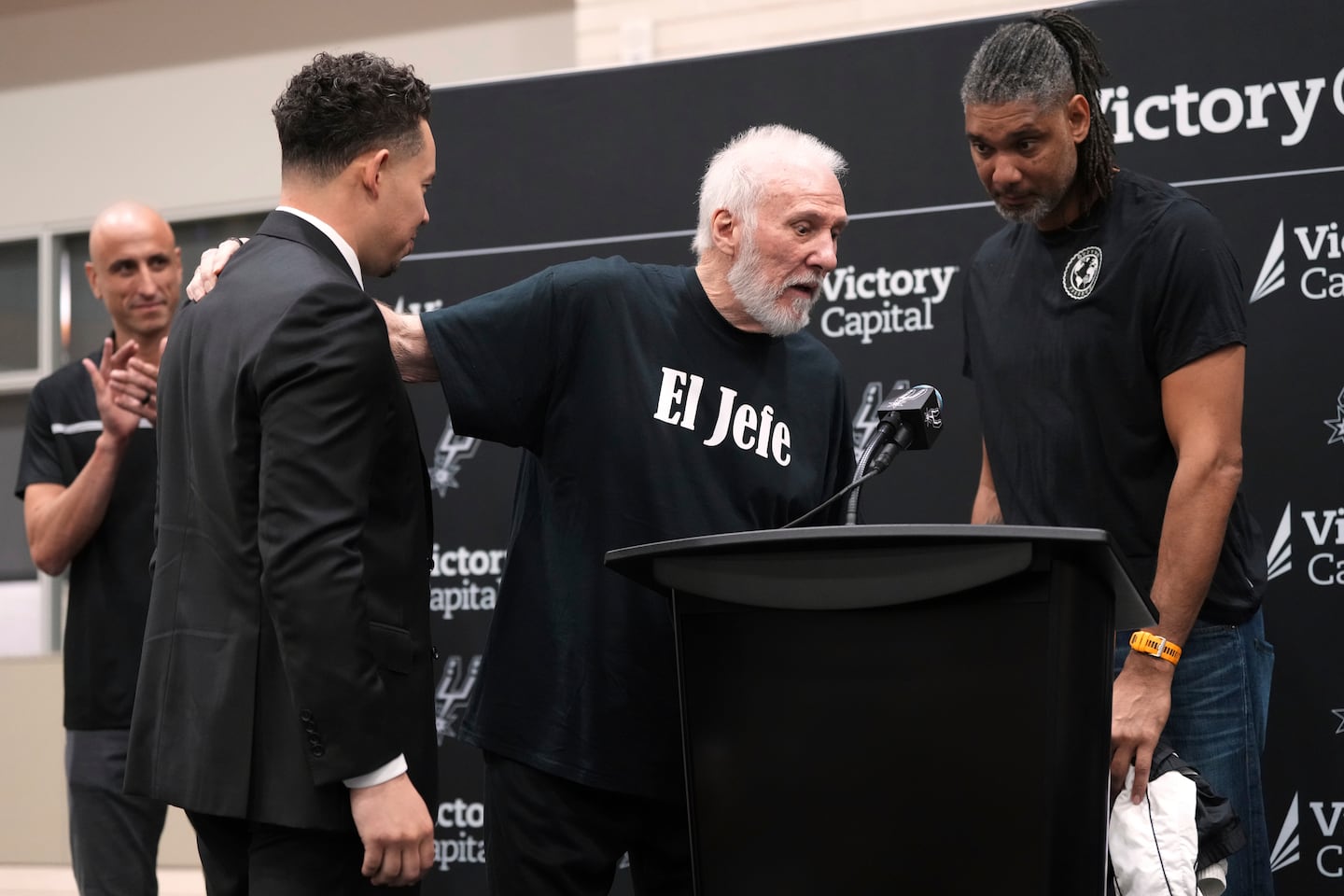With the help of former players Manu Ginobili (back left) and Tim Duncan (right) former Spurs coach Gregg Popovich introduces Mitch Johnson (front left) as the new coach.