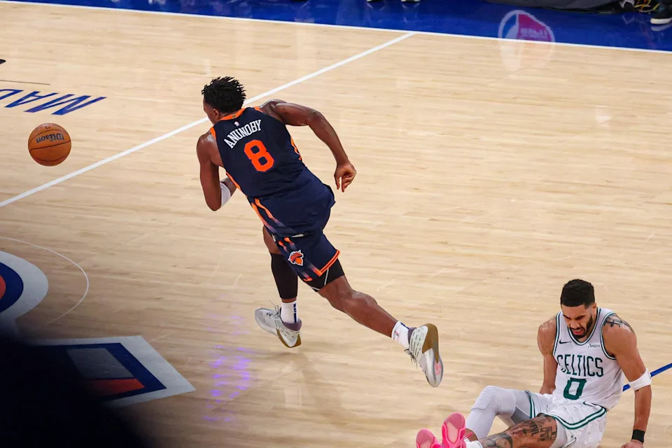 May 12, 2025; New York, New York, USA; New York Knicks forward OG Anunoby (8) rushes of the ball as Boston Celtics forward Jayson Tatum (0) reacts to an injury in the second half during game four of the second round for the 2025 NBA Playoffs at Madison Square Garden. Mandatory Credit: Vincent Carchietta-Imagn Images