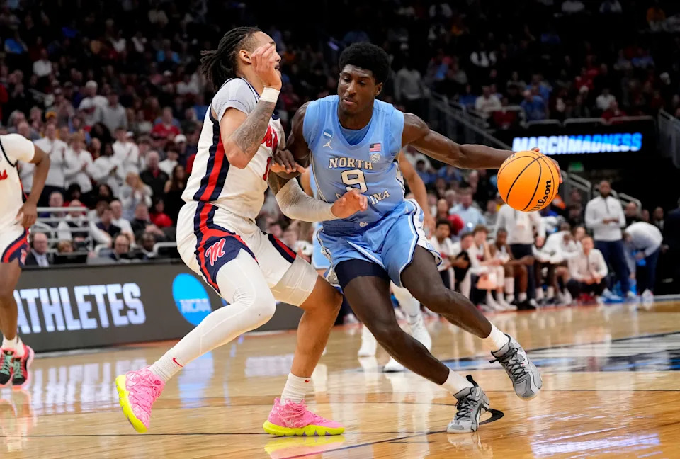 Mar 21, 2025; Milwaukee, WI, USA; North Carolina Tar Heels guard Drake Powell (9) drives against Mississippi Rebels guard Dre Davis (14) during the second half of a first round NCAA men’s tournament game at Fiserv Forum. Mandatory Credit: Jeff Hanisch-Imagn Images