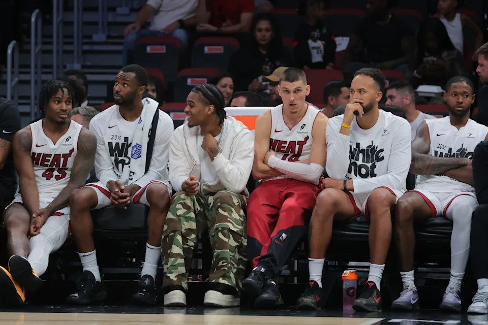Apr 28, 2025; Miami, Florida, USA; Miami Heat guard Tyler Herro (center) looks on from the bench against the Cleveland Cavaliers in the fourth quarter during game four for the first round of the 2025 NBA Playoffs at Kaseya Center. Mandatory Credit: Sam Navarro-Imagn Images