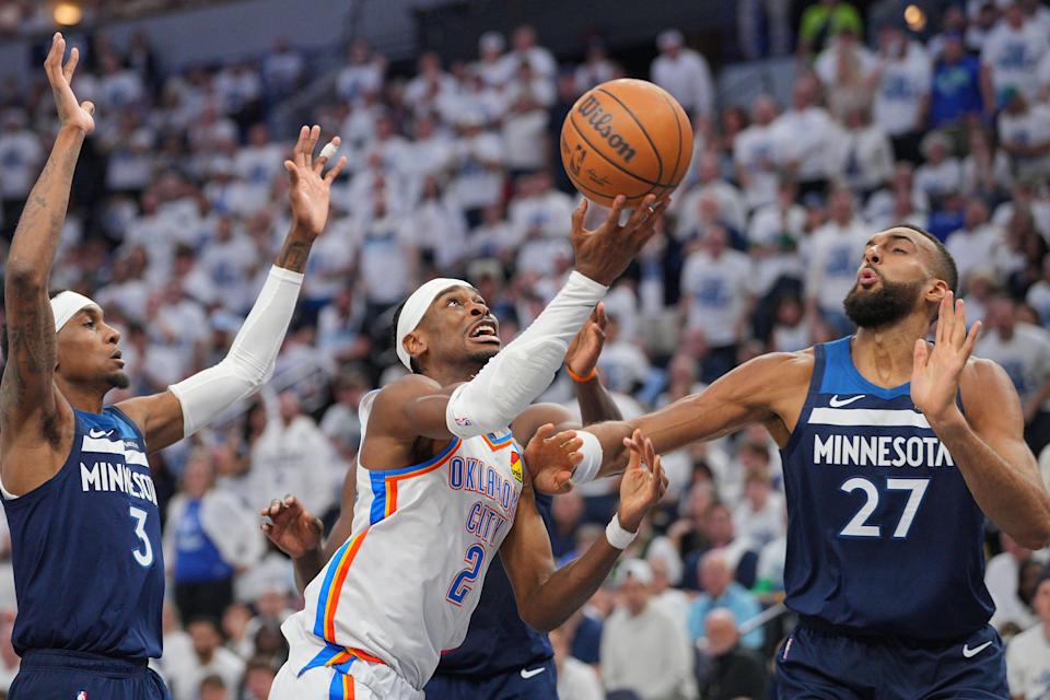 Oklahoma City Thunder guard Shai Gilgeous-Alexander (2) shoots the ball over Minnesota Timberwolves center Rudy Gobert (27) during the first half in Game 3 of the Western Conference finals at Target Center.