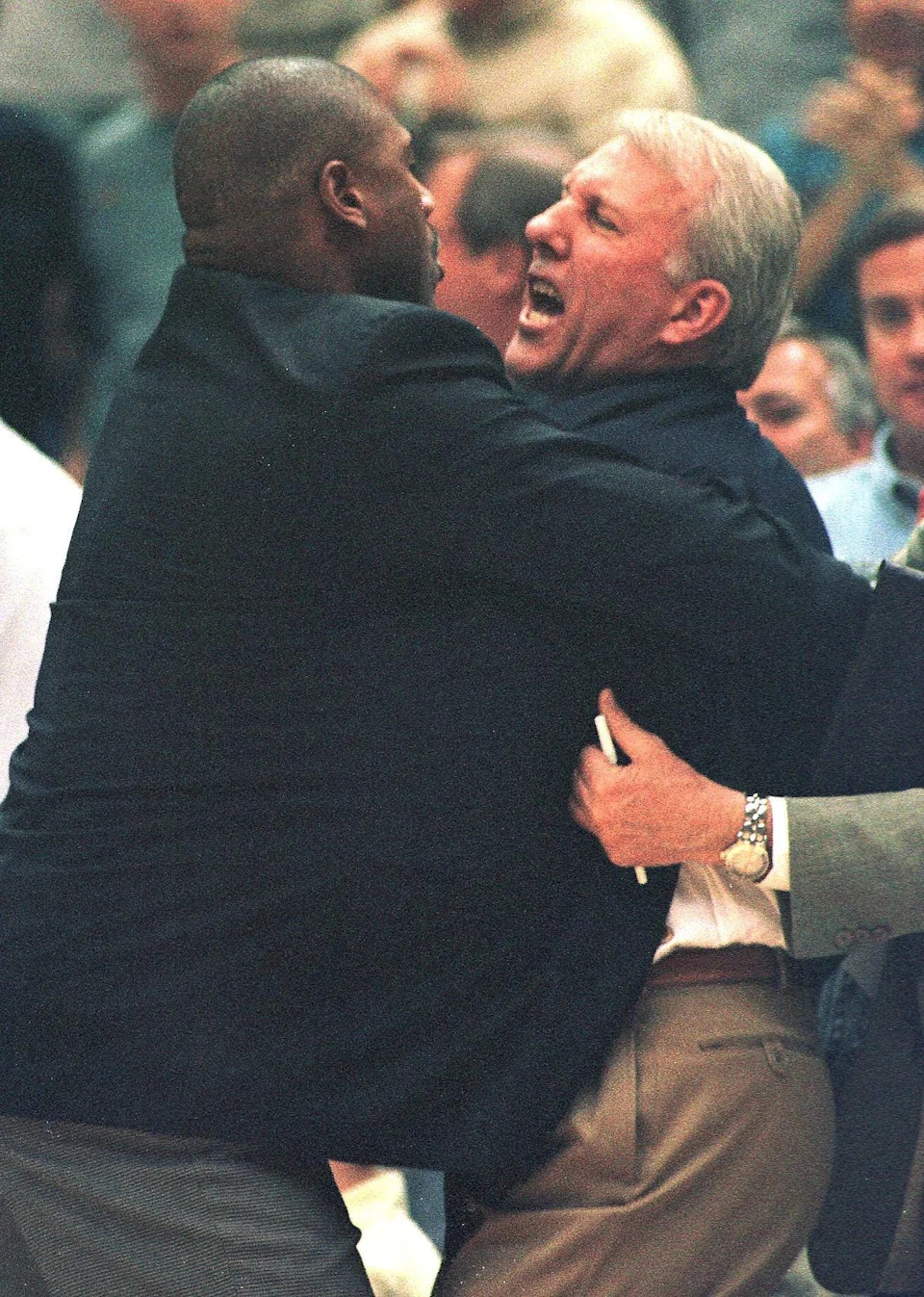 SALT LAKE CITY, UT - MAY 5: San Antonio Spurs' coach Greg Popovich is restrained by assistant coach Paul Pressey after arguing a call with the referee during the fourth quarter of game one of their NBA Western Conference semi-final series against the Utah Jazz.