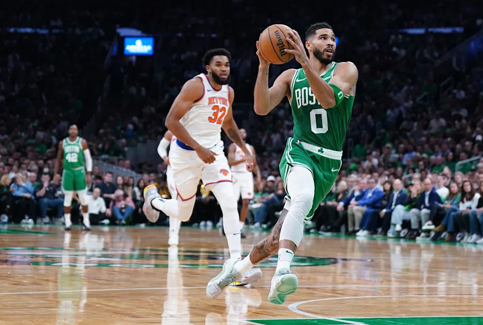 Celtics forward Jayson Tatum returns the ball to score against Knicks center Karl-Anthony Towns on Oct. 22.