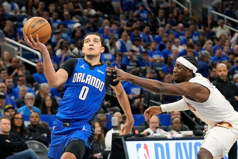 Orlando Magic guard Anthony Black (0) drives past Cleveland Cavaliers guard Caris LeVert for a basket during the second half of Game 4 of an NBA basketball first-round playoff series, Saturday, April 27, 2024, in Orlando, Fla. | John Raoux