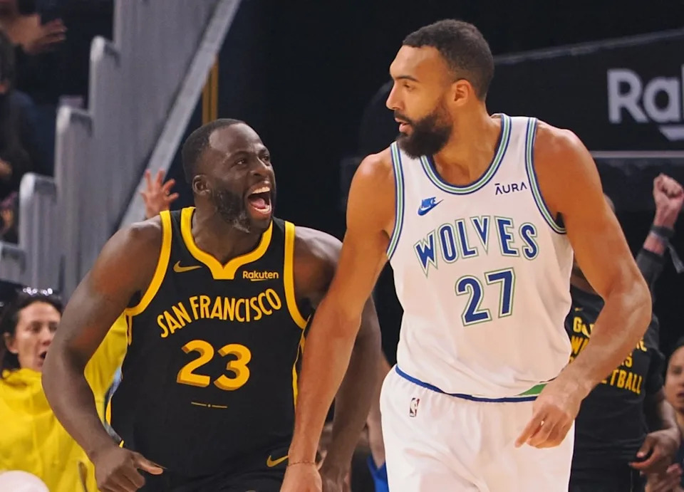Golden State Warriors forward Draymond Green (23) celebrates behind Minnesota Timberwolves center Rudy Gobert (27)Mandatory Credit: Kelley L Cox-Imagn Images