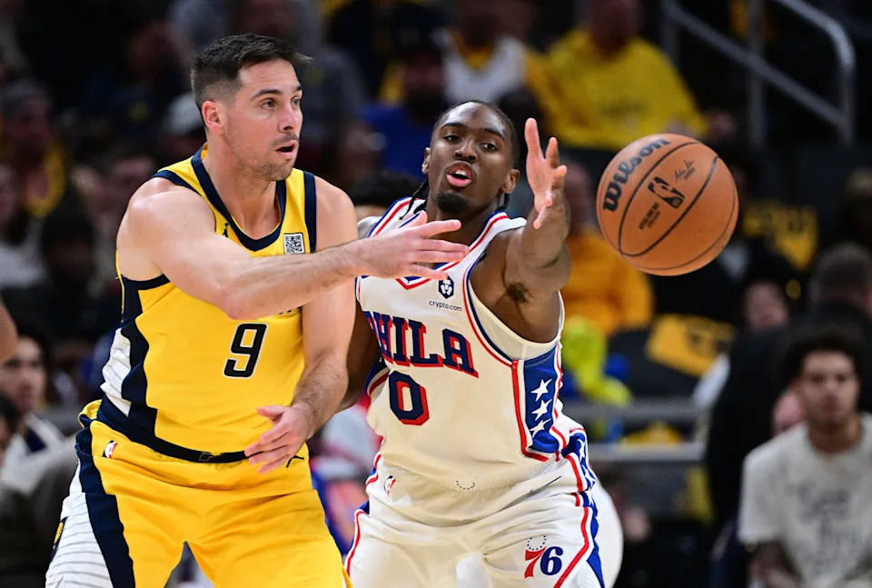 Indiana Pacers guard T.J. McConnell passes the ball around Philadelphia 76ers guard Tyrese Maxey during the second half at Gainbridge Fieldhouse.Marc Lebryk-Imagn Images