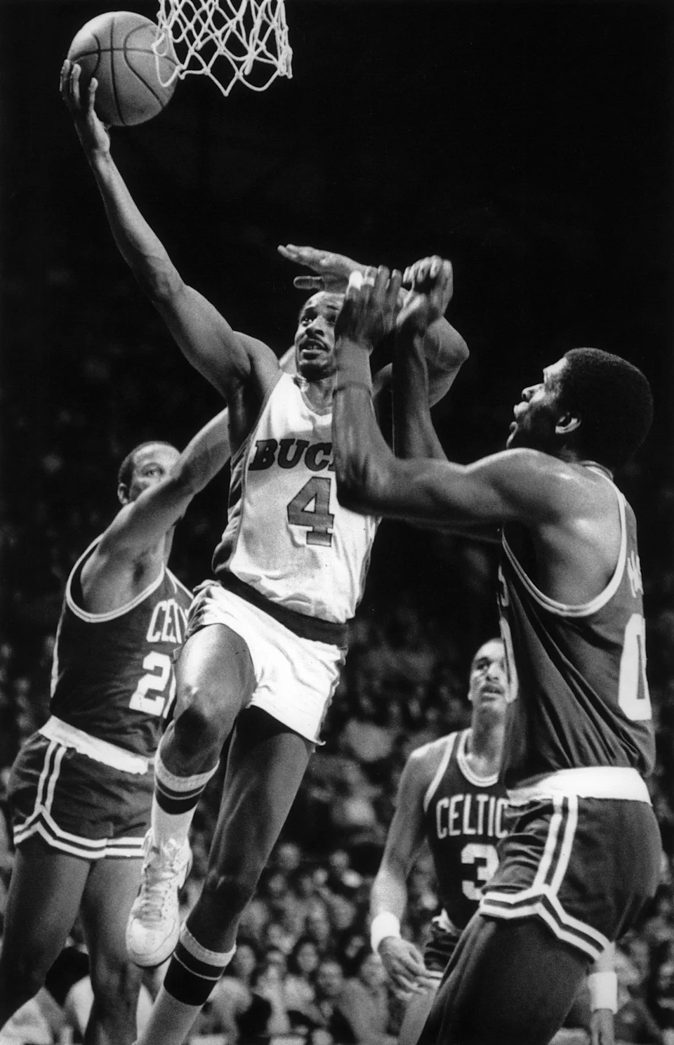 Milwaukee Bucks guard Sidney Moncrief gets a layup between Boston Celtics Ray Williams (left) and Robert Parish during a game on April 2, 1985, at the Milwaukee Arena. Moncrief was one of three Bucks to score 18 points as they led Milwaukee to a 109-103 victory.