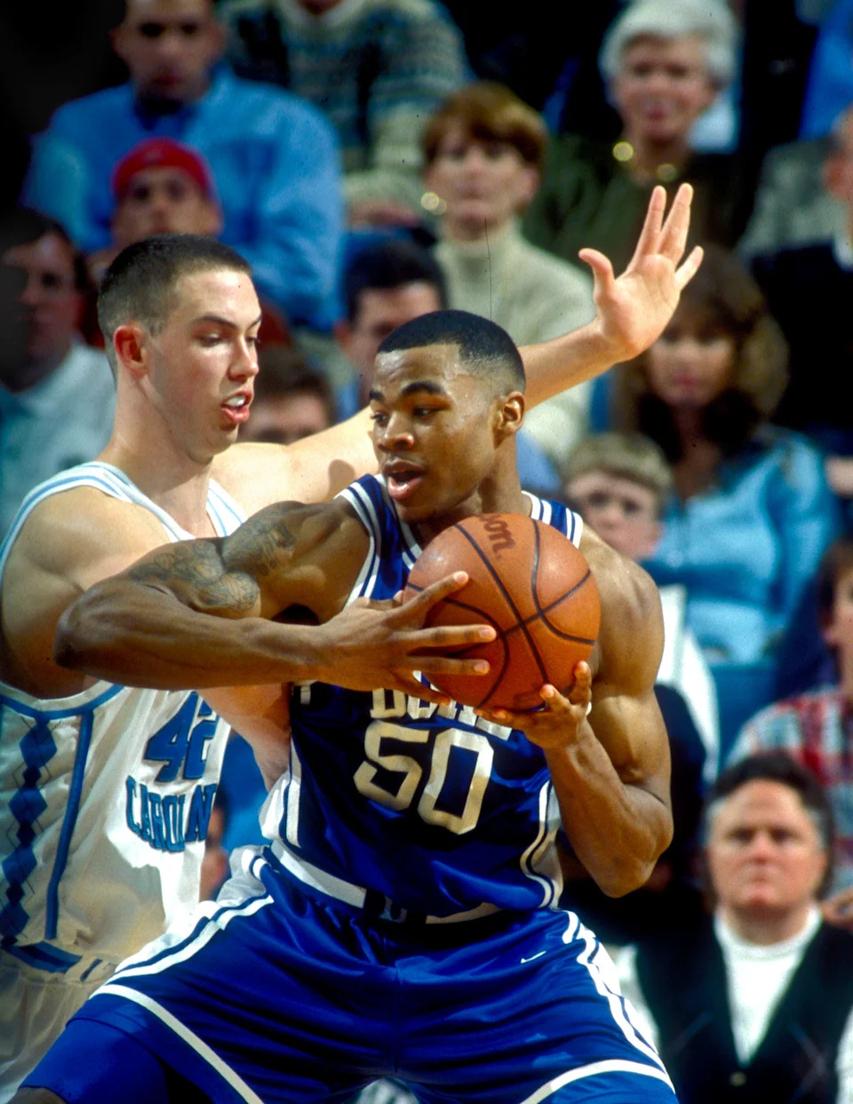 Duke Blue Devils forward Corey Maggette with the ball as North Carolina Tar Heels forward Kris Lang defends at the Dean E. Smith Center.