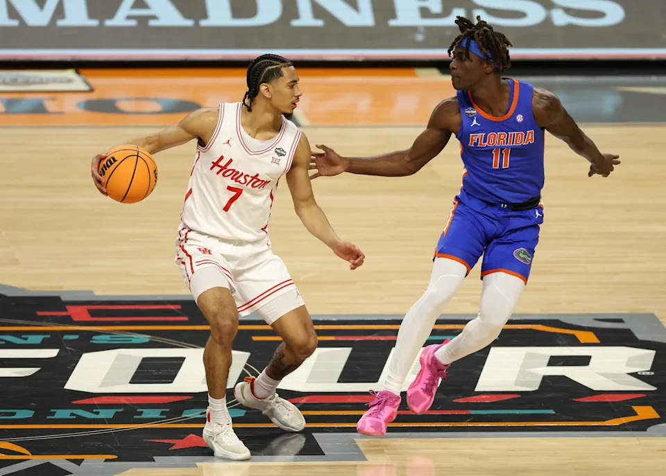 SAN ANTONIO, TEXAS - APRIL 07: Milos Uzan #7 of the Houston Cougars dribbles the ball against Denzel Aberdeen #11 of the Florida Gators during the first half in the National Championship of the NCAA Men's Basketball Tournament at the Alamodome on April 07, 2025 in San Antonio, Texas. (Photo by Sam Hodde/Getty Images)