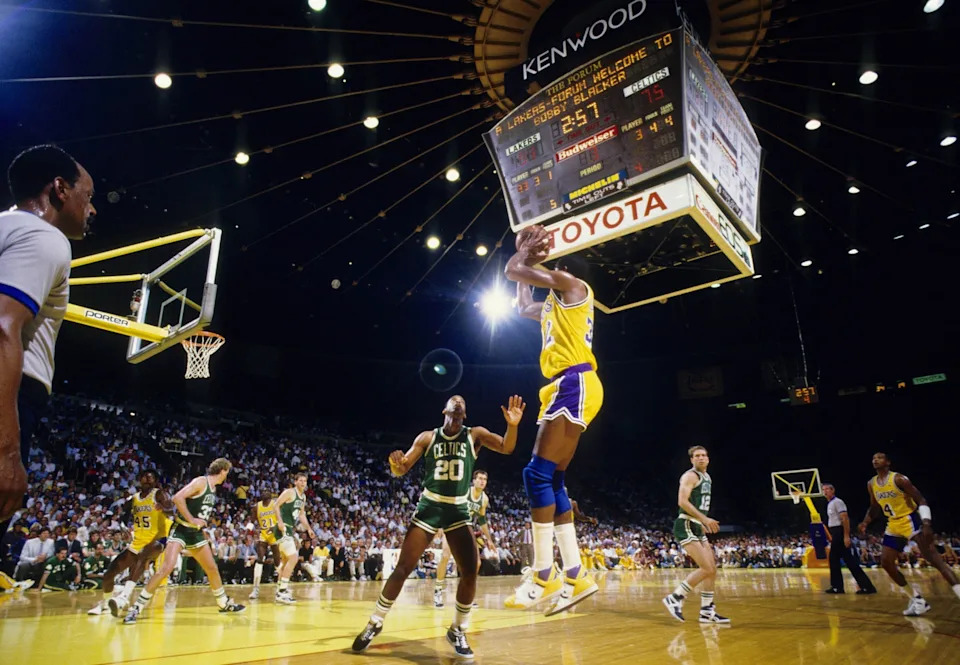 Jun 1987; Los Angeles, CA, USA; FILE PHOTO; Los Angeles Lakers guard Magic Johnson (32) shoots the ball over Boston Celtics forward Darren Daye (20) during the 1987 NBA Finals at The Forum. Mandatory Credit: MPS-USA TODAY Sports