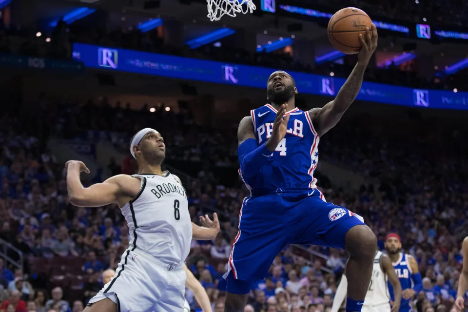 Apr 13, 2019; Philadelphia, PA, USA; Philadelphia 76ers forward Jonathon Simmons (14) scores past Brooklyn Nets forward Jared Dudley (6) during the second quarter in game one of the first round of the 2019 NBA Playoffs at Wells Fargo Center. Mandatory Credit: Bill Streicher-USA TODAY Sports