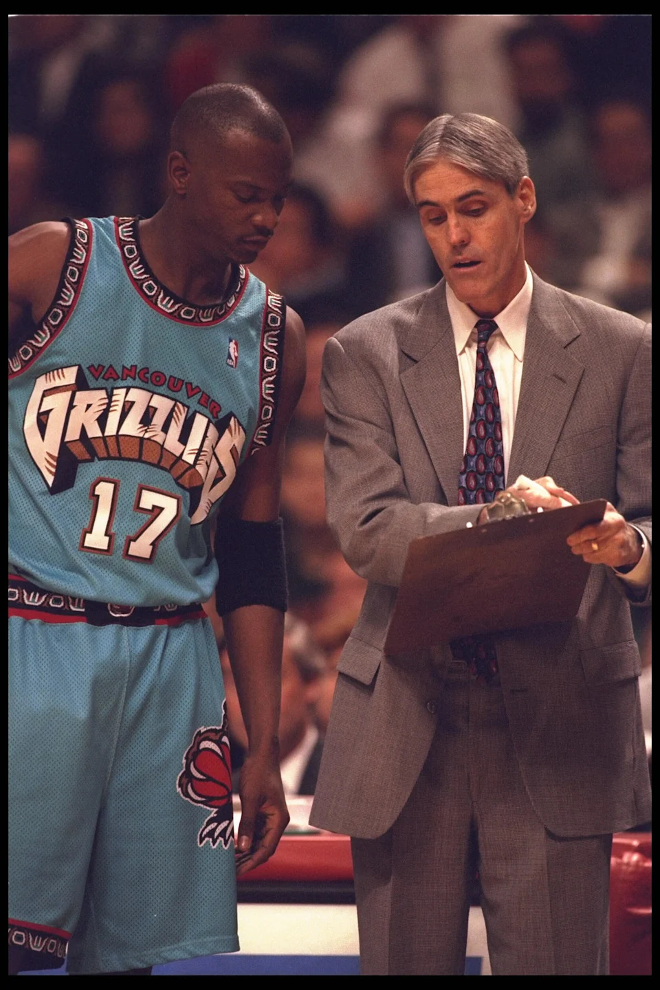 24 Jan 1996: Head coach Brian Winters discusses the strategy with player Chris King of the Vancouver Grizzlies at the United Center in Chicago, Illinois, during the game against the Chicago Bulls.