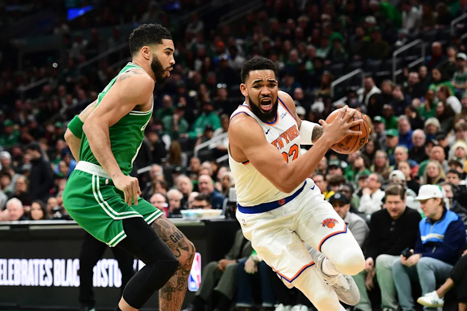 Feb 23, 2025; Boston, Massachusetts, USA; New York Knicks center Karl-Anthony Towns (32) controls the ball while Boston Celtics forward Jayson Tatum (0) defends during the first half at TD Garden.© Bob DeChiara-Imagn Images