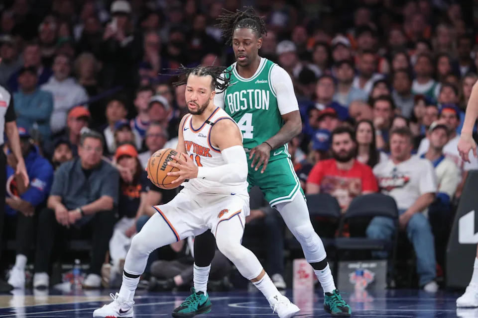 New York Knicks guard Jalen Brunson (11) looks to drive past Boston Celtics guard Jrue Holiday (4) at Madison Square Garden. © Wendell Cruz-Imagn Images