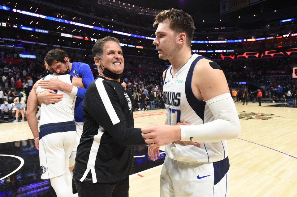 Luka Dončić of the Dallas Mavericks hugging team owner Mark Cuban after a playoff game.