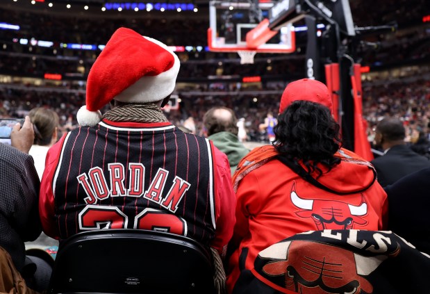 Bulls fans wearing team apparel watch a game against the Denver Nuggets on Dec. 12, 2023, at the United Center. (Chris Sweda/Chicago Tribune)