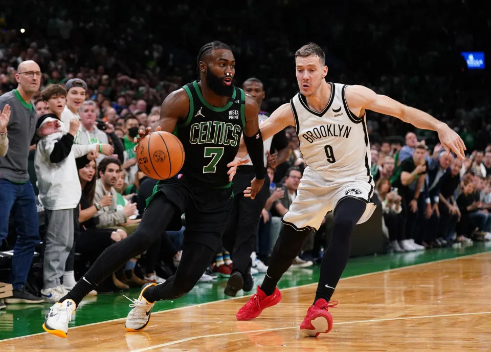 Apr 17, 2022; Boston, Massachusetts, USA; Boston Celtics guard Jaylen Brown (7) drives the ball against Brooklyn Nets guard Goran Dragic (9) in the second half during game one of the first round for the 2022 NBA playoffs at TD Garden. Mandatory Credit: David Butler II-USA TODAY Sports