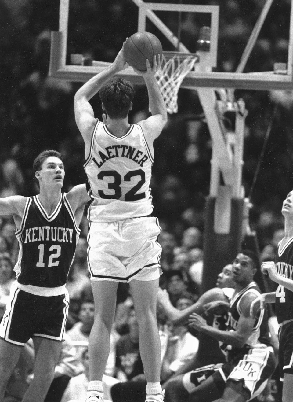 Christian Laettner gets off a last-second shot to defeat the Kentucky Wildcats in the NCAA tournament in Philadelphia.