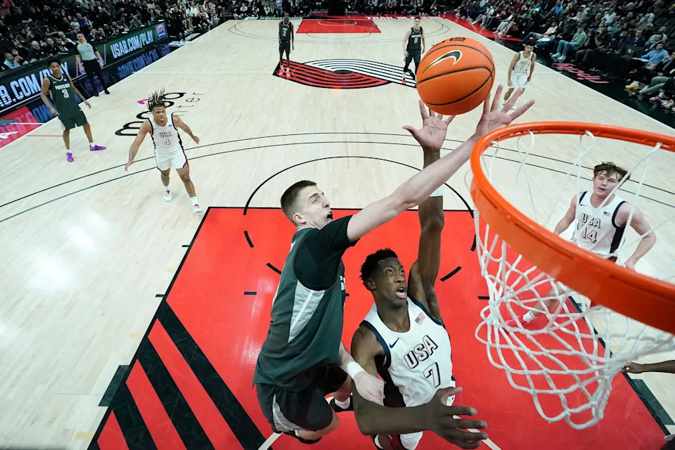 PORTLAND, OREGON - APRIL 12: AJ Dybantsa #7 of Team USA and Bogoljub Markovic (L) #6 of Team World battle for a rebound during the 2025 Nike Hoop Summit at Moda Center on April 12, 2025 in Portland, Oregon. (Photo by Soobum Im/Getty Images)