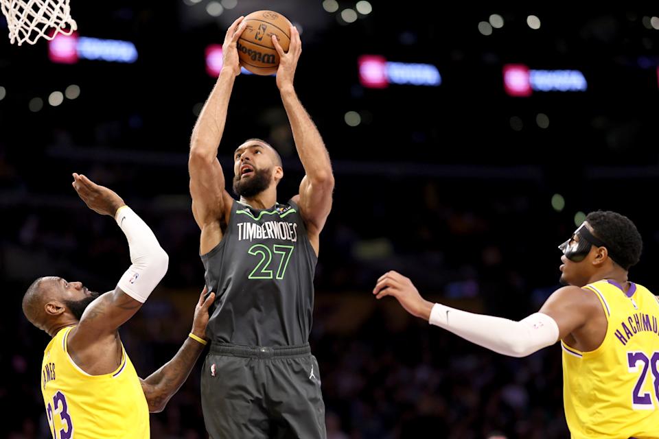 Los Angeles, CA, Wednesday, April 30, 2025 - Minnesota Timberwolves center Rudy Gobert (27) shoots against Los Angeles Lakers forward LeBron James (23), left, and Los Angeles Lakers forward Rui Hachimura (28) in the first quarter. The LA Lakers and the Minnesota Timberwolves in game five of the first round of the NBA playoffs at Crypto.com Arena.  (Robert Gauthier/Los Angeles Times via Getty Images)