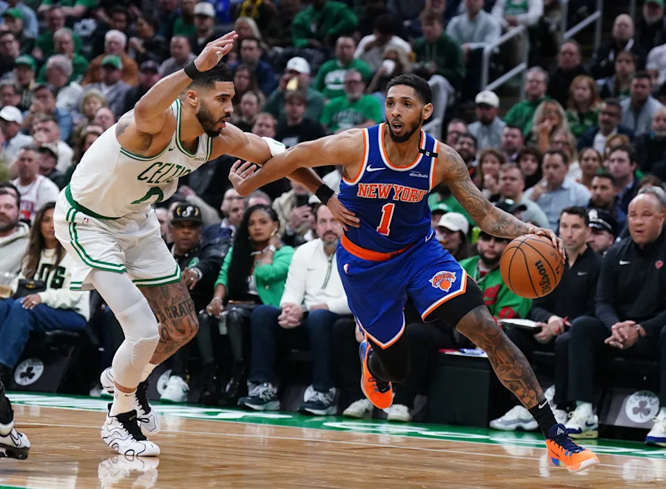 May 5, 2025; Boston, Massachusetts, USA; New York Knicks guard Cameron Payne (1) drives the ball against Boston Celtics forward Jayson Tatum (0) in the first quarter during game one of the second round for the 2025 NBA Playoffs at TD Garden. Mandatory Credit: David Butler II-Imagn Images