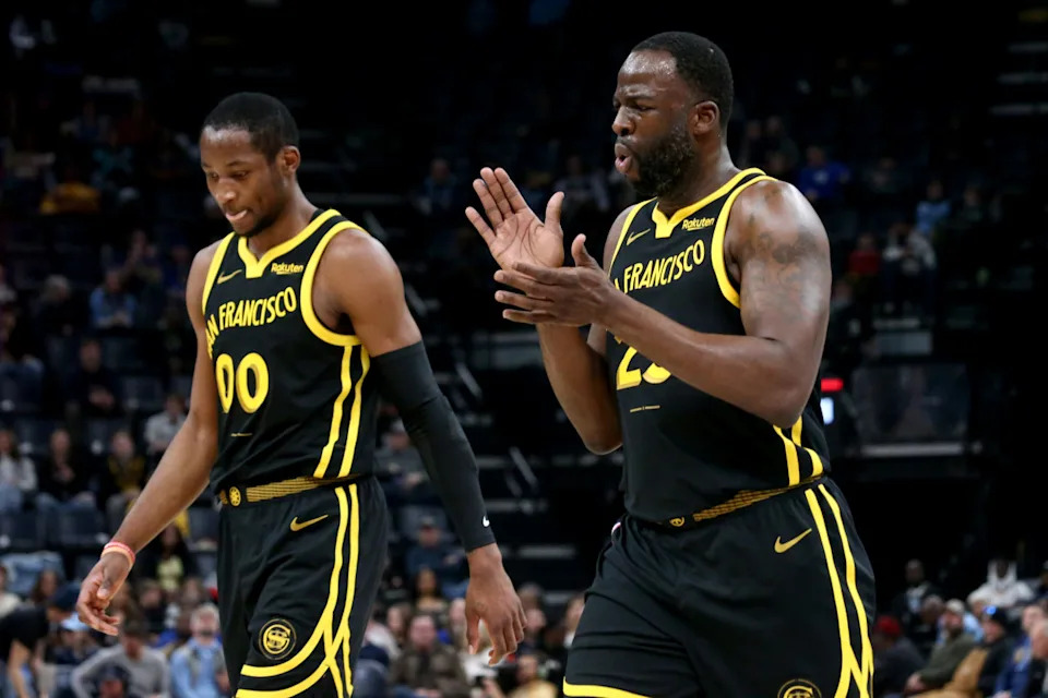 Jan 15, 2024; Memphis, Tennessee, USA; Golden State Warriors forward Jonathan Kuminga (00) and Golden State Warriors forward Draymond Green (23) walk to the bench at the end of the first quarter against the Memphis Grizzlies at FedExForum.© Petre Thomas-Imagn Images