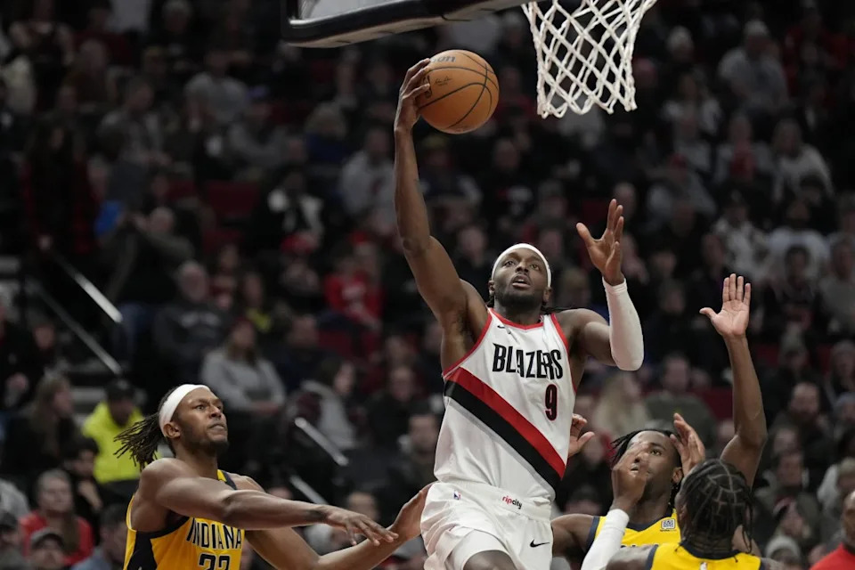 Jan 19, 2024; Portland, Oregon, USA; Portland Trail Blazers small forward Jerami Grant (9) shoots the ball past Indiana Pacers small forward Aaron Nesmith (23, right) during the second half at Moda Center. Mandatory Credit&colon; Soobum Im-Imagn Images