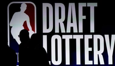People walk by a sign during the NBA basketball draft lottery in Chicago, Tuesday, May 16, 2023.