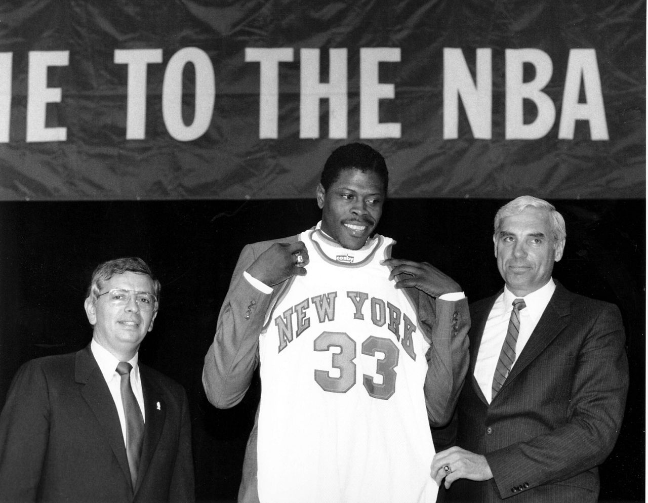 In this June 18, 1985, file photo, Patrick Ewing accepts his New York Knicks jersey from Dave DeBusschere, right, general manager of the Knicks, as NBA commissioner David Stern look on, at the NBA Draft in New York.