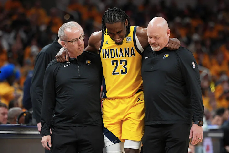 Indiana Pacers forward Aaron Nesmith (23) is assisted off the court during the second half of Game 3 of the Eastern Conference finals of the NBA basketball playoffs against the New York Knicks Sunday, May 25, 2025, in Indianapolis. (AP Photo/AJ Mast)