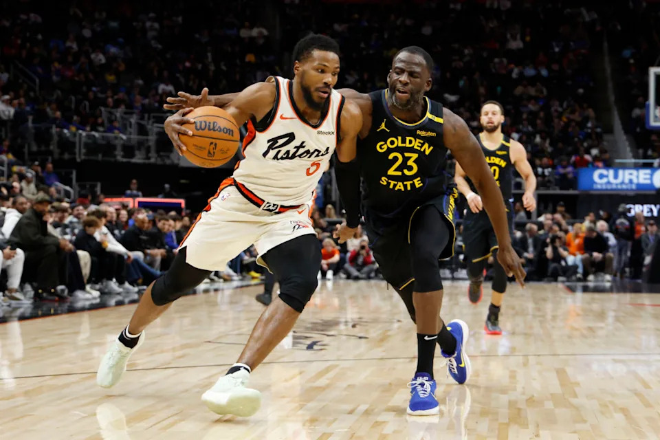 Jan 9, 2025; Detroit, Michigan, USA; Detroit Pistons guard Malik Beasley (5) dribbles on Golden State Warriors forward Draymond Green (23) in the first half at Little Caesars Arena.© Rick Osentoski-Imagn Images