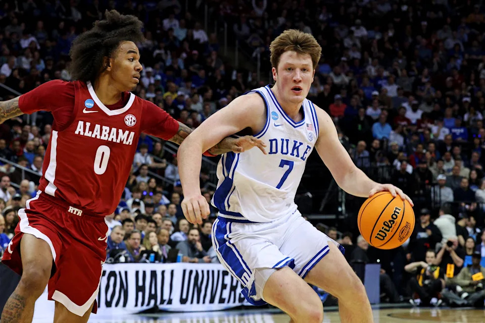 Mar 29, 2025; Newark, NJ, USA; Duke Blue Devils guard Kon Knueppel (7) drives to the basket against Alabama Crimson Tide guard Labaron Philon (0) during the first half in the East Regional final of the 2025 NCAA tournament at Prudential Center. Mandatory Credit: Vincent Carchietta-Imagn Images