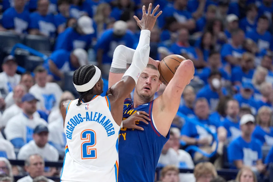 Denver Nuggets center Nikola Jokic (15) tries to pass as Oklahoma City Thunder guard Shai Gilgeous-Alexander (2) defends during Game 5 of the NBA playoff series between the Oklahoma City Thunder and the Denver Nuggets at Paycom Center in Oklahoma City, Tuesday, May 13, 2025.