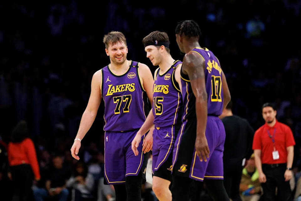 Lakers guard Luka Doncic, left, shares a laugh with teammates Austin Reaves, center, and Dorian Finney-Smith.