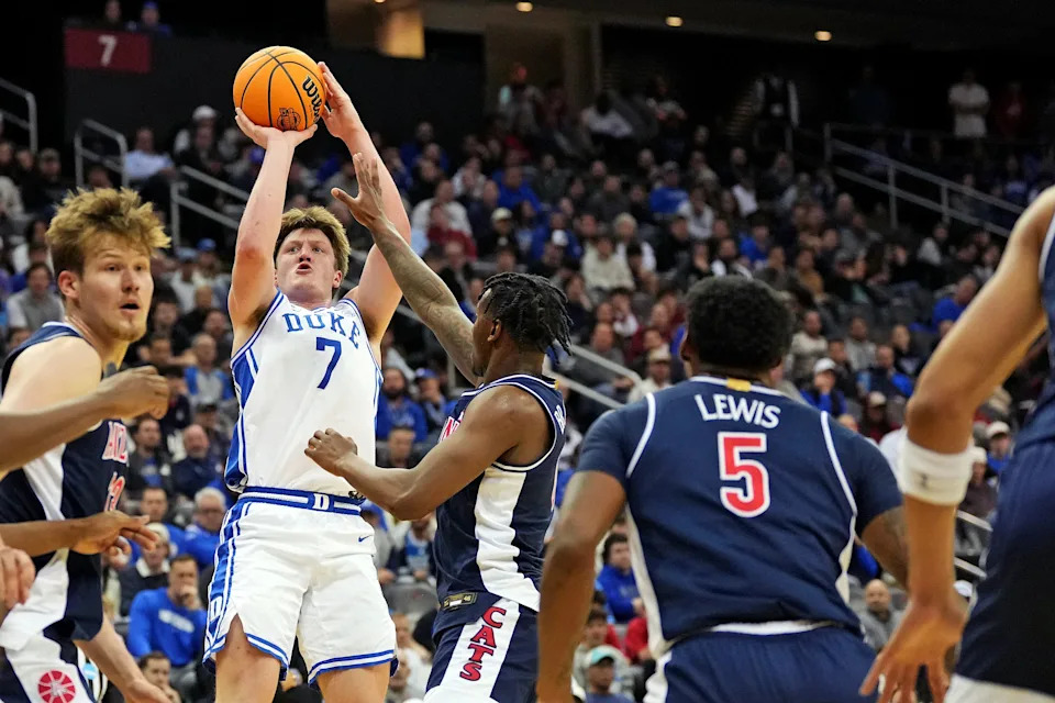 Mar 27, 2025; Newark, NJ, USA; Duke Blue Devils guard Kon Knueppel (7) shoots the ball against Arizona Wildcats guard KJ Lewis (5) during the second half during an East Regional semifinal of the 2025 NCAA tournament at Prudential Center. Mandatory Credit: Robert Deutsch-Imagn Images