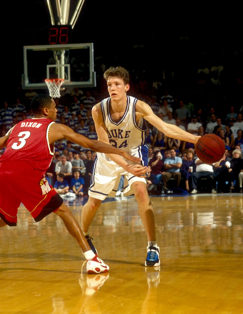 Duke Blue Devils forward Mike Dunleavy looks to pass as Maryland Terrapins guard Juan Dixon defends at Cameron Indoor Stadium.
