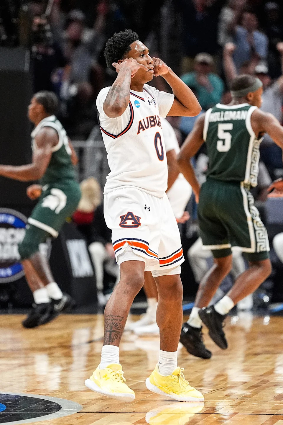 Auburn guard Tahaad Pettiford celebrates a 3-point basket against Michigan State early in the first half of the Elite Eight round of the NCAA tournament at State Farm Arena in Atlanta on Sunday, March 30, 2025.