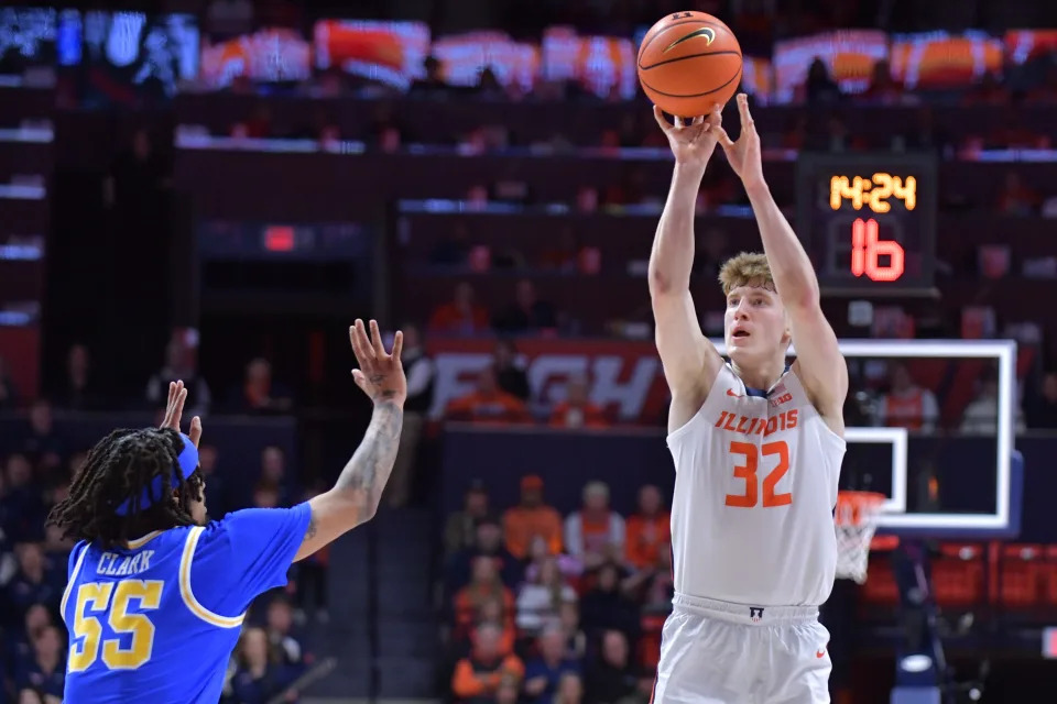 Feb 11, 2025; Champaign, Illinois, USA; Illinois Fighting Illini guard Kasparas Jakucionis (32) shoots the ball over UCLA Bruins guard Skyy Clark (55) during the first half at State Farm Center. Mandatory Credit: Ron Johnson-Imagn Images