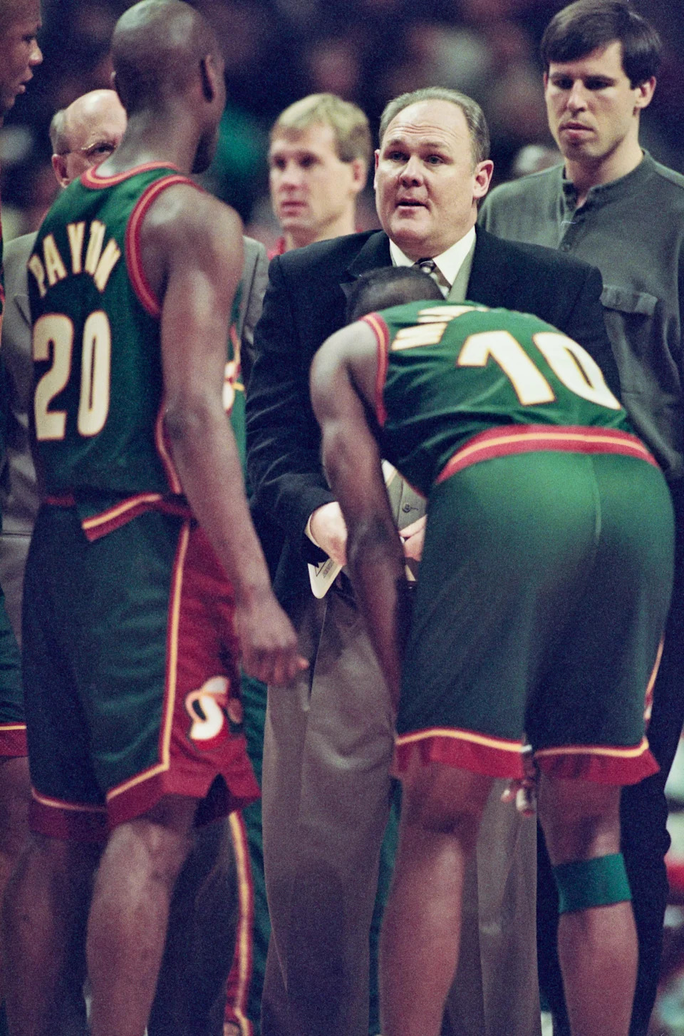 George Karl, Head Coach for the Seattle SuperSonics talks with Gary Payton and Nate McMillan during ga,me against the Chicago Bulls on March 19, 1997 at the United Center in Chicago.