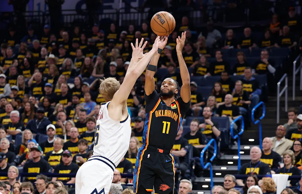 May 7, 2025; Oklahoma City, Oklahoma, USA; Oklahoma City Thunder guard Isaiah Joe (11) shoots a three point basket over Denver Nuggets forward Hunter Tyson (5) in the second half during game two of the second round for the 2025 NBA Playoffs at Paycom Center. Mandatory Credit: Alonzo Adams-Imagn Images