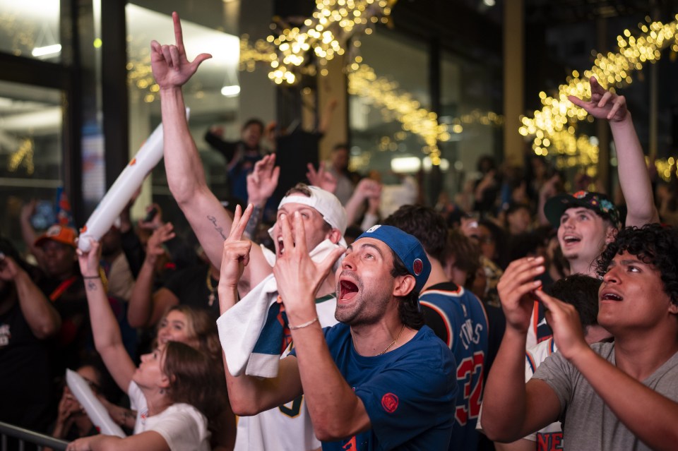 New York Knicks fans cheering outside Madison Square Garden.