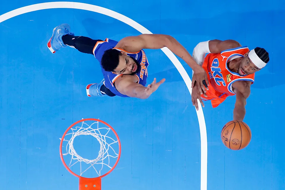 Oklahoma City Thunder guard Shai Gilgeous-Alexander (2) puts up a shot beside New York Knicks center Karl-Anthony Towns (32) during an NBA basketball game between the Oklahoma City Thunder and the New York Knicks at Paycom Center in Oklahoma City, Friday, Jan. 3, 2025.