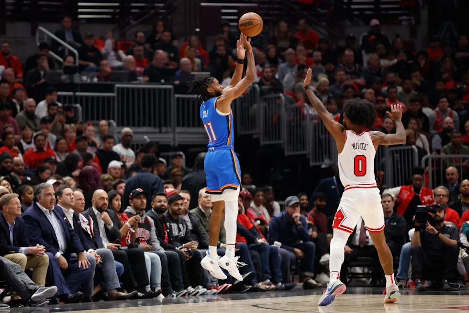 Oct 25, 2023; Chicago, Illinois, USA; Oklahoma City Thunder guard Isaiah Joe (11) shoots against Chicago Bulls guard Coby White (0) during the first half of a basketball game at United Center.© Kamil Krzaczynski-Imagn Images