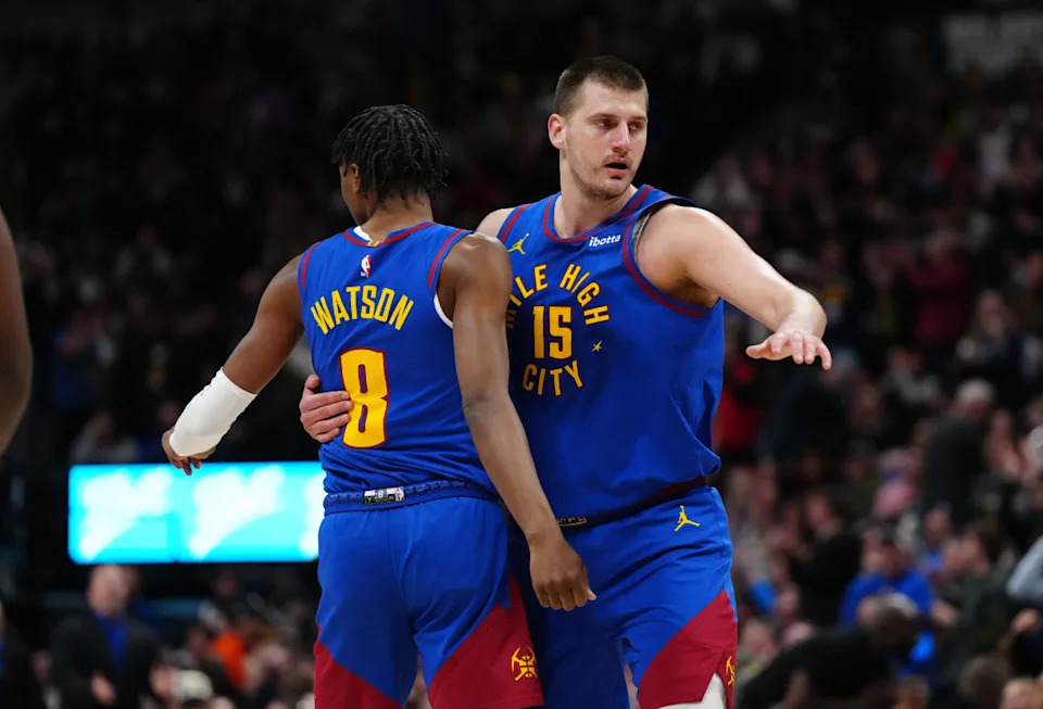 Mar 5, 2024; Denver, Colorado, USA; Denver Nuggets forward Peyton Watson (8) and center Nikola Jokic (15) react in the first half against the Phoenix Suns at Ball Arena. © Ron Chenoy-Imagn Images
